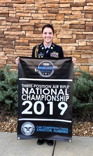 Megan Nelson holding the banner she earned for her school at the National Championships. 